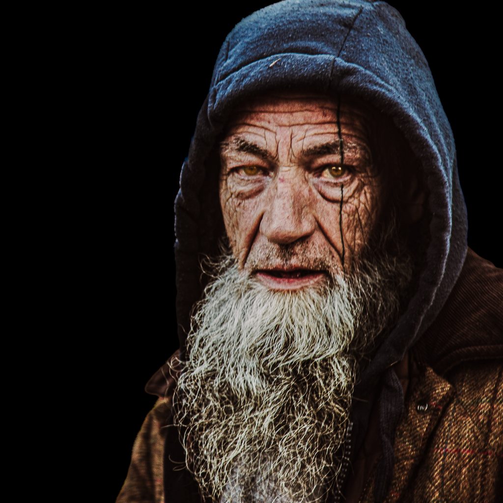 High Contrast Colour portrait of a man with a long white beard, featuring an intense direct gaze